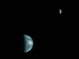 Although not totally clear, this is the first picture of Earth ever taken from another planet that shows it as a planetary disk. Here, we see the Earth and the moon from Mars, captured by the NASA Mars Global Surveyor on May 8, 2003. 
Source: NASA/JPL/Malin Space Science Systems
