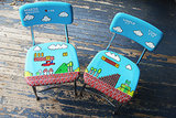 Just picture it now . . . you and a friend playing on this hand-painted Mario chair set ($175). Doesn't get any better. 
