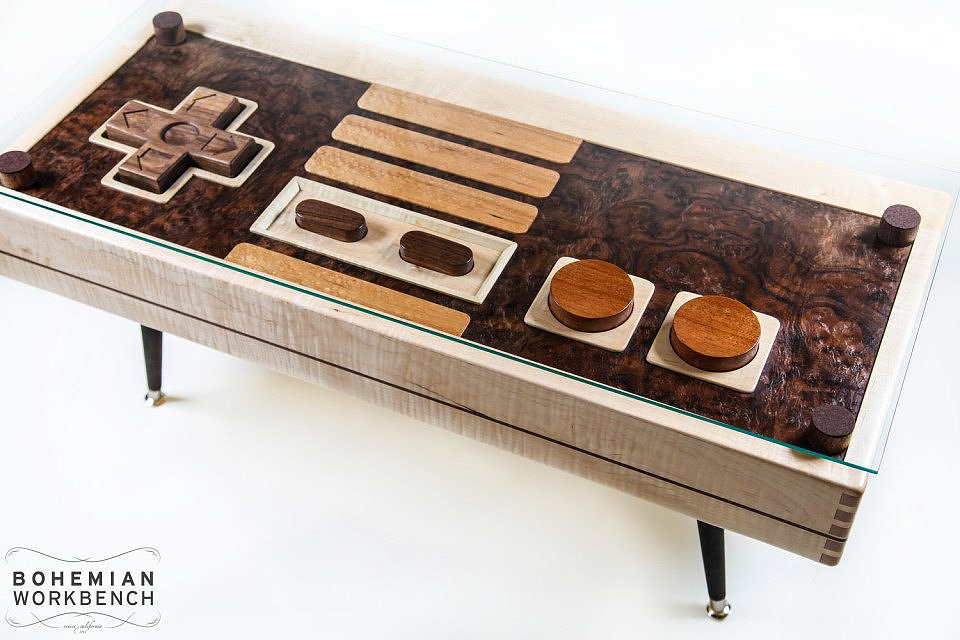 Stop everything, because compared to similar Nintendo controller coffee tables, this wood one ($395) is a steal. 
